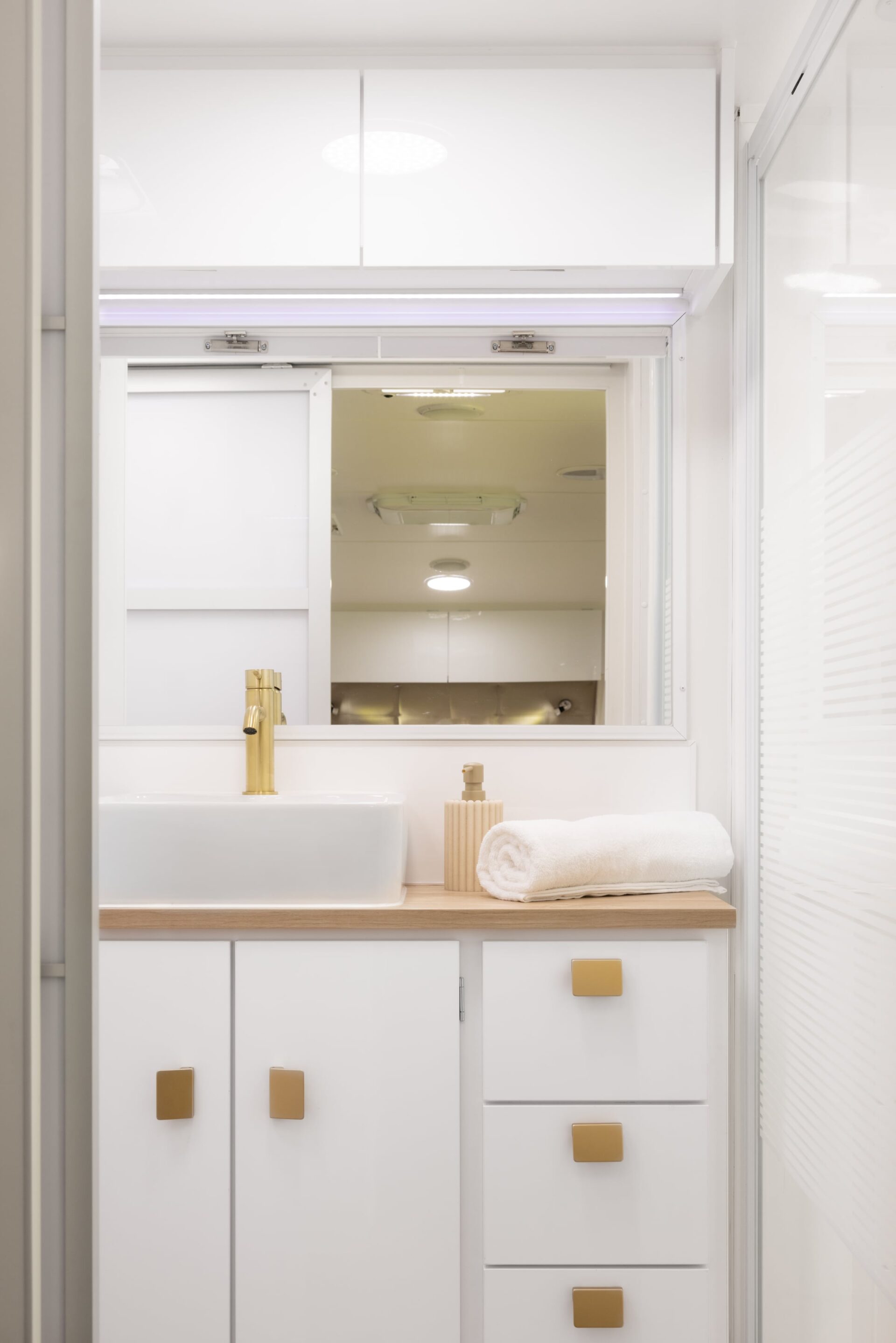 Supreme Classic Tourer ensuite bathroom interior — vanity with mirror and gold tapware
