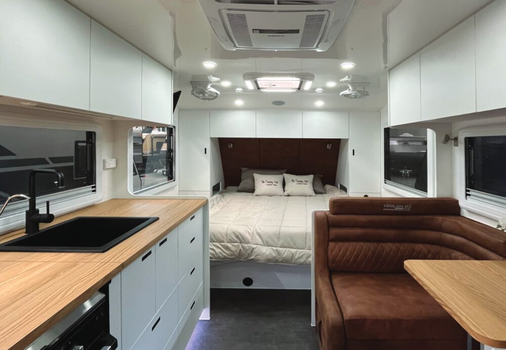 Urban Tungsten X-Treme X caravan interior — kitchen, dinette and queen bed shown together — Urban brochure 2026
